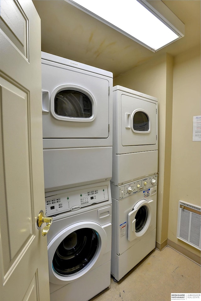 laundry area with stacked washing maching and dryer