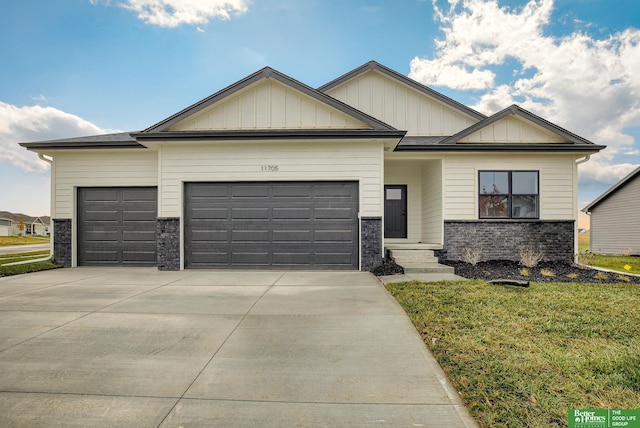 view of front of house with a garage and a front lawn