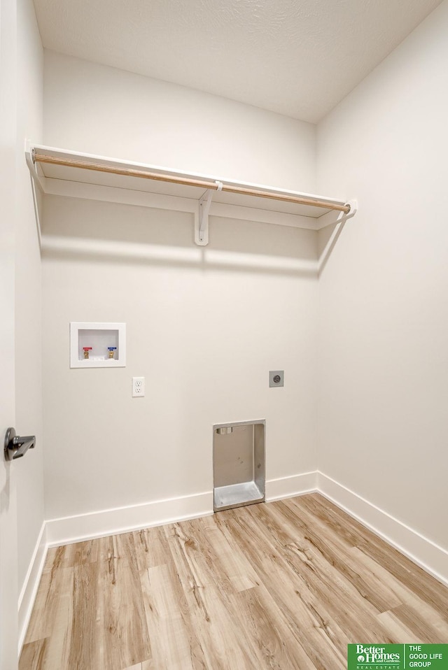 washroom with electric dryer hookup, hardwood / wood-style flooring, and washer hookup