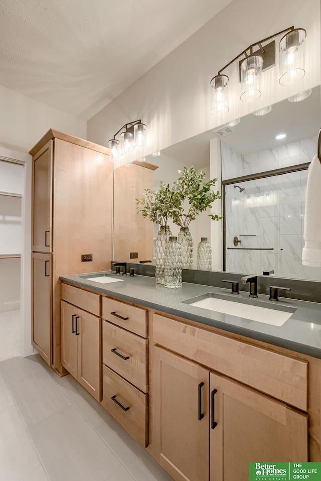 bathroom with vanity, tile patterned flooring, and walk in shower