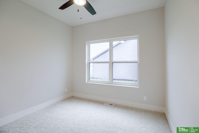 carpeted spare room with ceiling fan