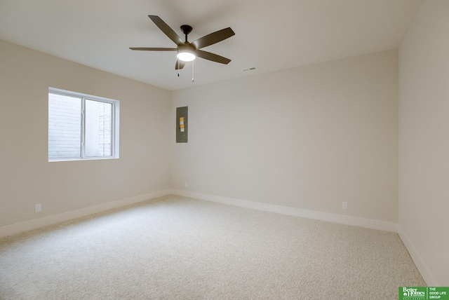 carpeted spare room with electric panel and ceiling fan