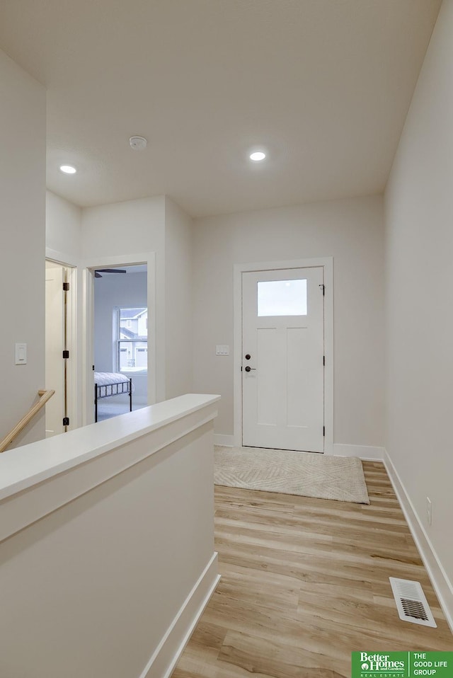 foyer entrance with light wood-type flooring