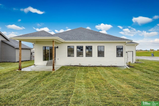 back of house featuring a patio area and a lawn