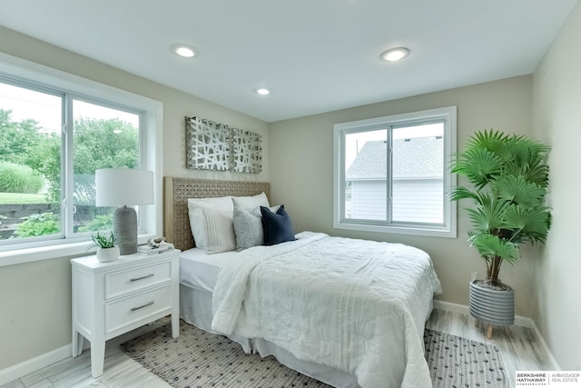 bedroom featuring light hardwood / wood-style flooring and multiple windows