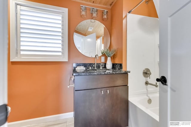 bathroom with vanity, washtub / shower combination, and wood-type flooring