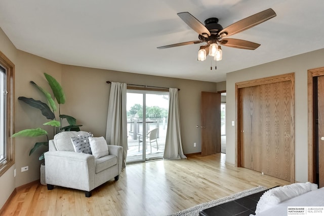 sitting room featuring light hardwood / wood-style floors and ceiling fan