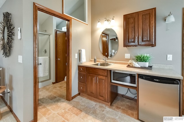 bathroom with a shower with door and vanity