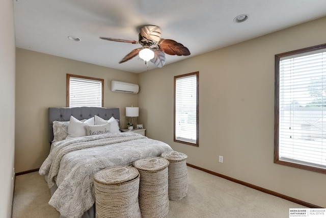 bedroom with a wall mounted AC, light carpet, multiple windows, and ceiling fan