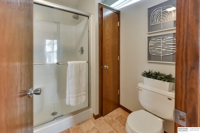 bathroom with toilet and an enclosed shower