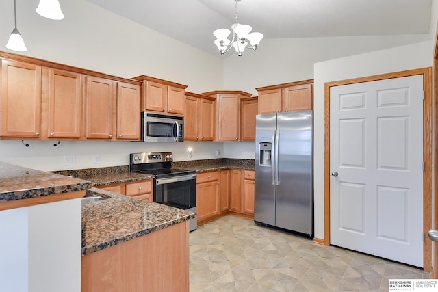 kitchen with lofted ceiling, dark stone counters, hanging light fixtures, a notable chandelier, and appliances with stainless steel finishes