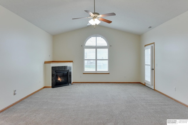 unfurnished living room with ceiling fan, light colored carpet, and lofted ceiling