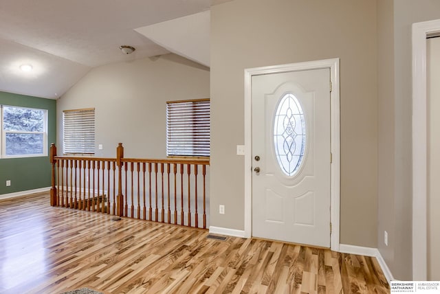 entryway featuring light hardwood / wood-style floors, lofted ceiling, and a wealth of natural light