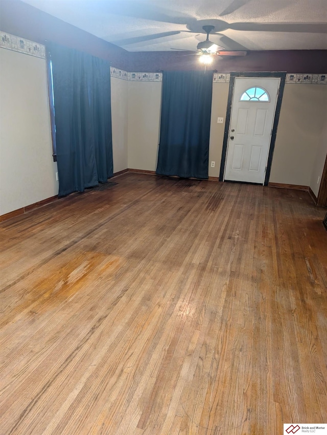 entrance foyer featuring ceiling fan and hardwood / wood-style flooring