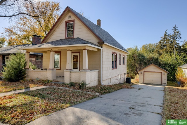 bungalow-style home with central air condition unit, a garage, a porch, and an outdoor structure