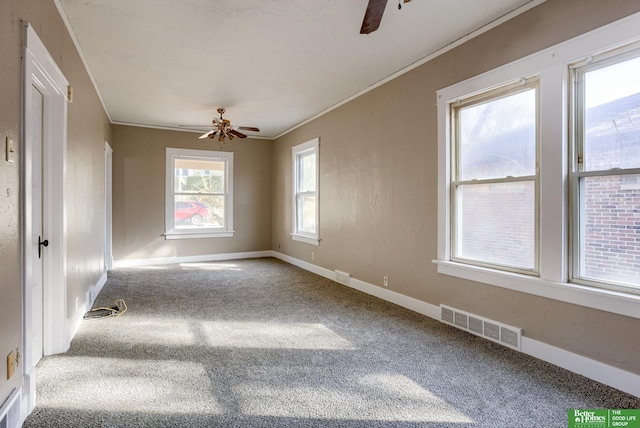 carpeted empty room featuring ornamental molding and ceiling fan