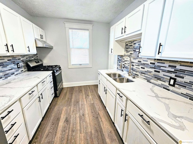 kitchen with dark wood-type flooring, sink, a textured ceiling, white cabinetry, and stainless steel range with gas stovetop