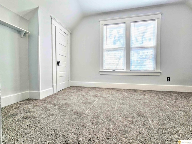 bonus room with carpet and vaulted ceiling