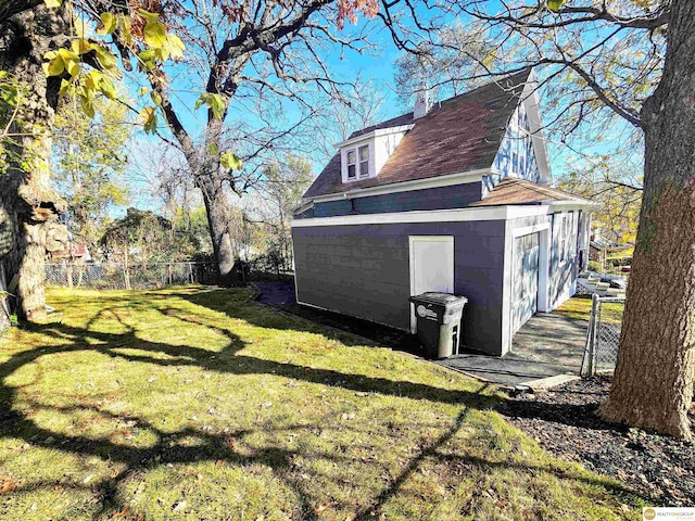 view of side of home with a lawn