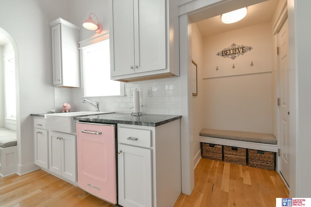 kitchen with light hardwood / wood-style flooring, white cabinetry, and sink