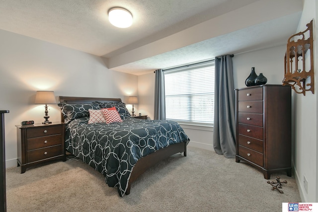 carpeted bedroom featuring a textured ceiling