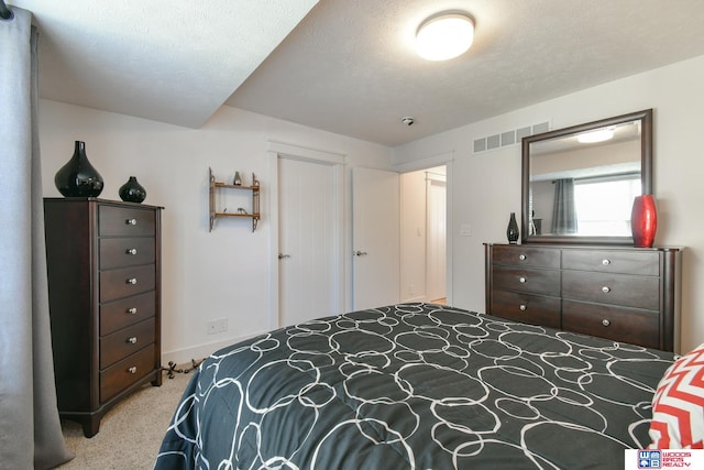 carpeted bedroom with a textured ceiling