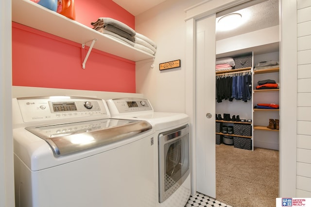 laundry area featuring light carpet and washer and clothes dryer