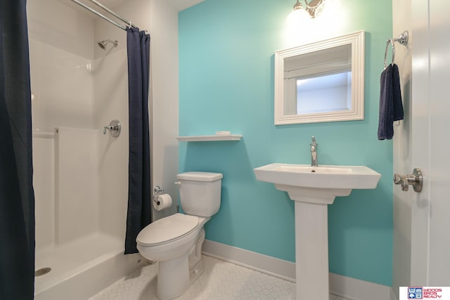 bathroom with toilet, tile patterned floors, and curtained shower