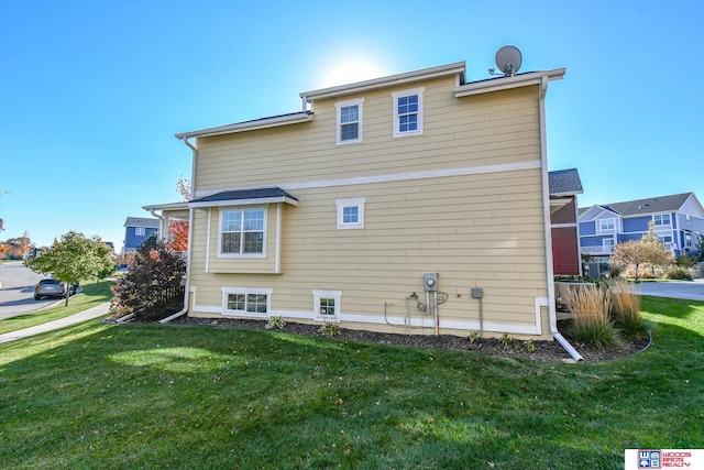 view of property exterior featuring a lawn