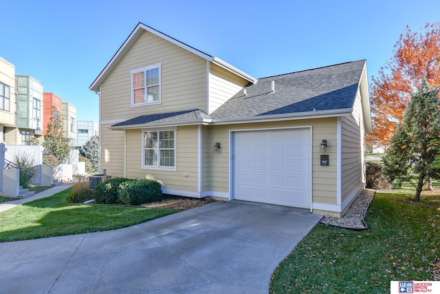 view of front of property with a front lawn, central AC, and a garage