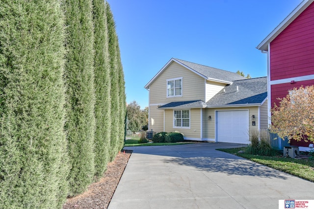 view of property with central AC and a garage