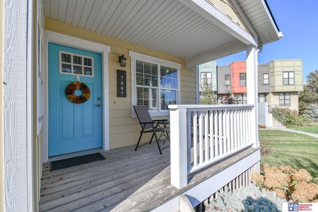 wooden terrace featuring covered porch