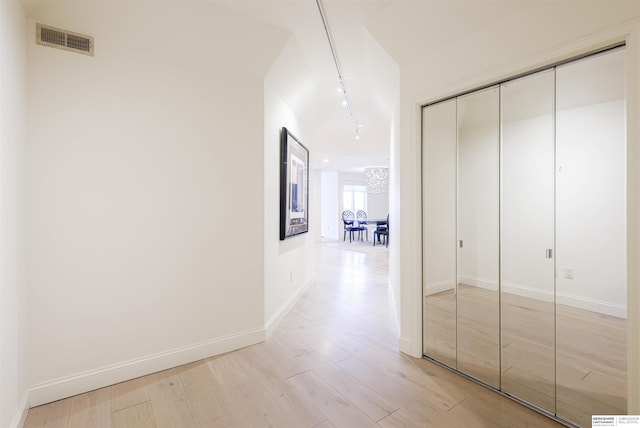 corridor featuring track lighting and light wood-type flooring