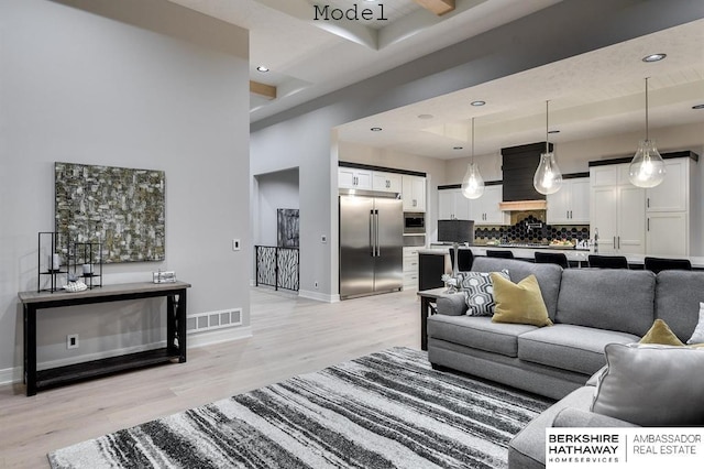 3902 S 212th St, Omaha, NE 68022 - living area featuring light wood finished floors, baseboards, recessed lighting, and a high ceiling