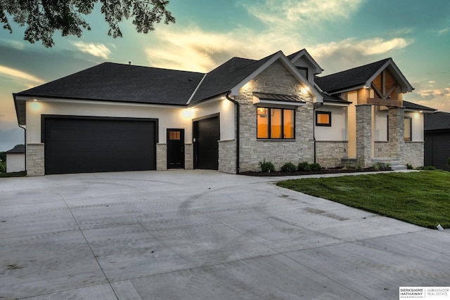 view of front facade with a yard and a garage