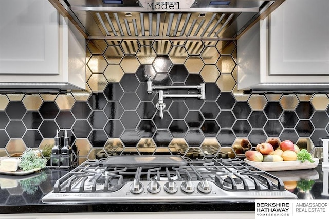 3902 S 212th St, Omaha, NE 68022 - kitchen view of pot filler, backsplash, white cabinets, and stainless steel gas cooktop
