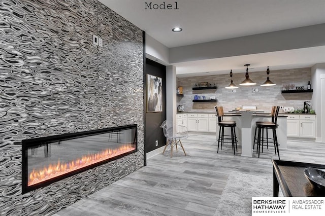 3902 S 212th St, Omaha, NE 68022 - living room featuring a glass covered fireplace, light wood-style floors, and recessed lighting