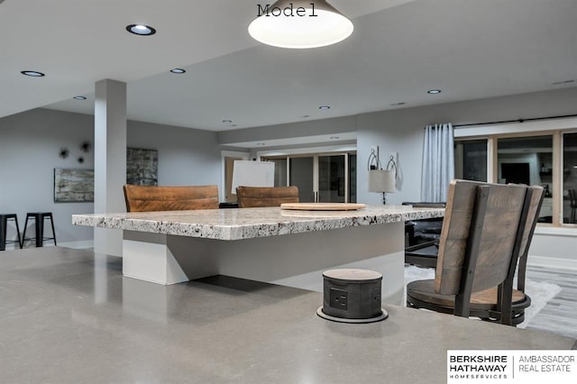 3902 S 212th St, Omaha, NE 68022 - kitchen with recessed lighting, a center island, light stone countertops, and a breakfast bar area