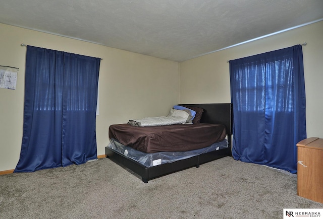 carpeted bedroom featuring a textured ceiling