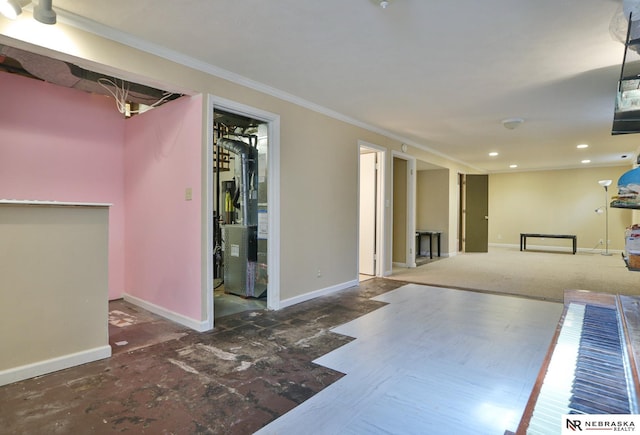 interior space with ornamental molding, heating unit, and ensuite bath