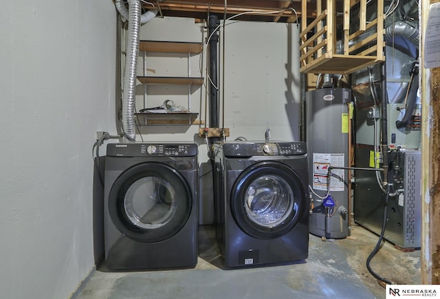 laundry room with gas water heater, independent washer and dryer, and heating unit