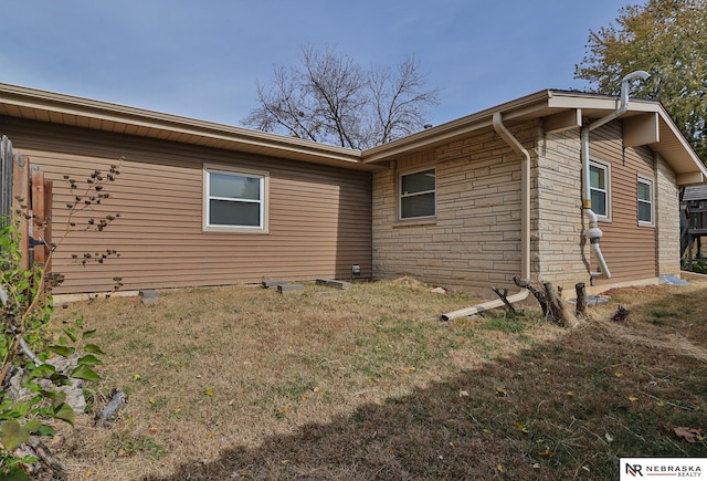 view of side of property with a lawn