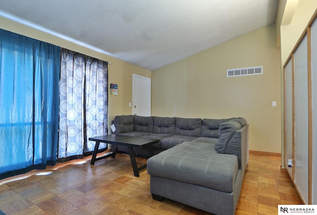 living room with lofted ceiling and light parquet floors