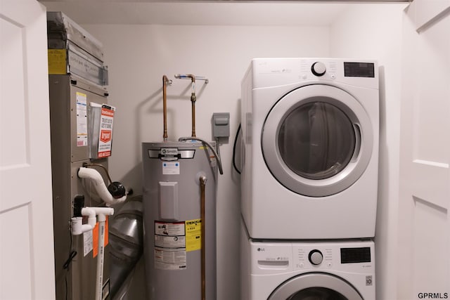 laundry area with water heater and stacked washer and dryer