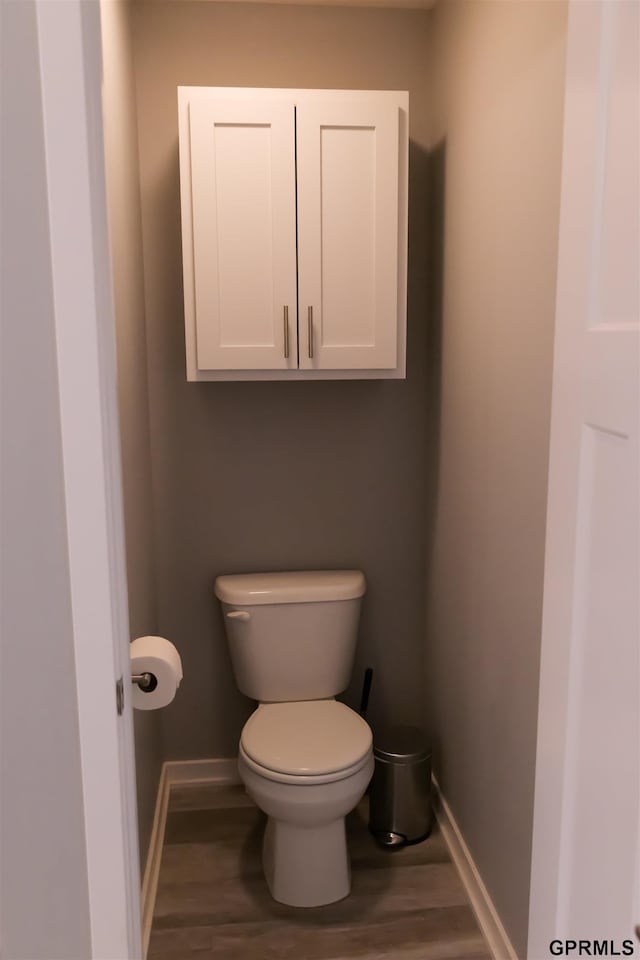 bathroom featuring hardwood / wood-style floors and toilet