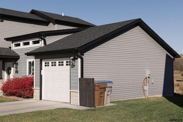 view of home's exterior with a yard and a garage