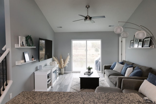 living room with lofted ceiling, light hardwood / wood-style floors, and ceiling fan