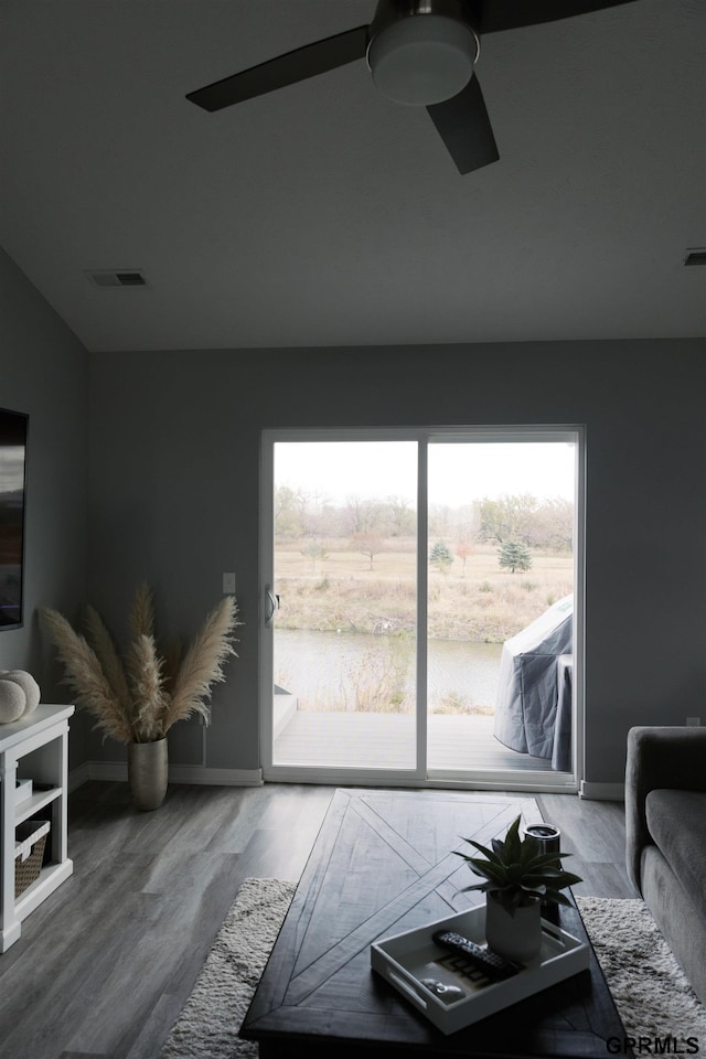 living room with wood-type flooring and ceiling fan