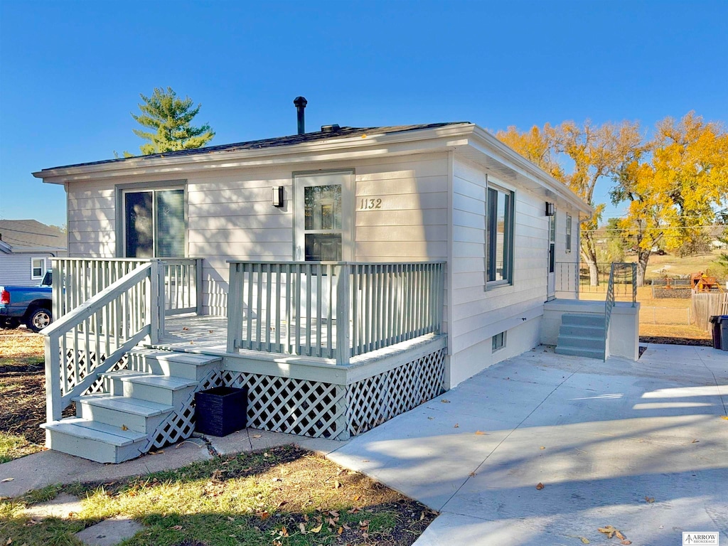 bungalow-style house with a patio and a deck