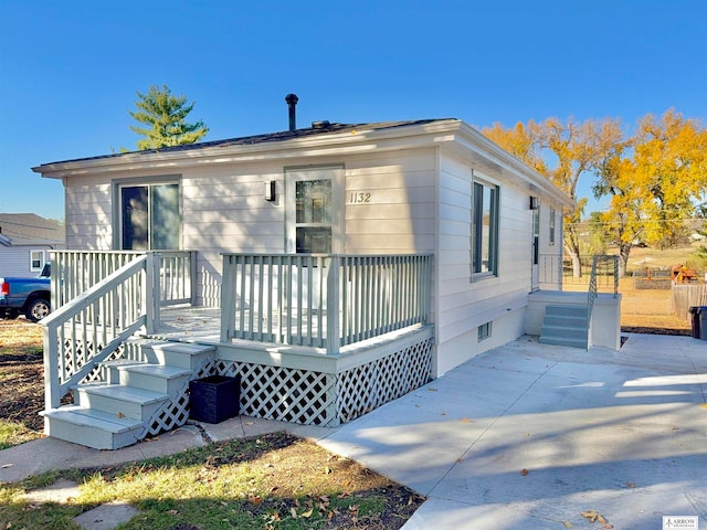 bungalow-style house with a patio and a deck